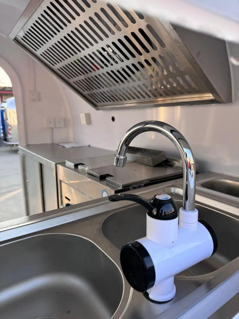 Ready To Roll Custom Mobile Food Truck Trailer With Commercial Kitchen stainless steel sink and faucet for food prep.