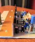 Side view of a Two Pack FR4 Single Sided Copper Clad PCB Board with mounted electronic components for DIY projects.