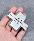 Person holding Concealed Cross Hinges Set Of Two In 304 Stainless Steel for table and counter doors
