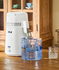 Zero Sweat 1.1 Gallon Water Distiller Smooth Countertop Pure Water Maker Featuring 750W fast processing on wooden table.