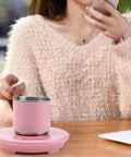 Electric Desk Cup Warmer And Cooler For Coffee Mugs Cans Bottles Precise Hot Cold Temp Control Keep Your Daily Brew Cozy Or Truly Ice Chill Home Office Game Changer Easy Wipe Surface with pink cup and warmer on wooden desk.