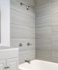 Eastport Two-Handle Tub And Shower Faucet In Satin Nickel installed in modern bathroom, showing showerhead and tub spout.