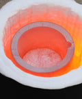 Inside view of Heavy Duty Graphite Crucible With Smooth Pouring Spout For Melting Aluminum Up To 1800 C, show glowing interior.