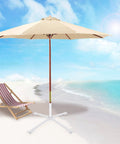 Adjustable Portable Foldable Beach Anchor Base For Outdoor Sunshade Stand And Patio Umbrella on sand with ocean background.