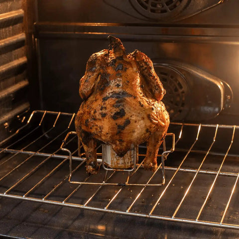 Premium Stainless Steel Beer Can Chicken Roaster Stand For Grill And Smoker With Handle Fits Regular 12 Ounce Cans Secure Bottom Crossbar Easy Outdoor BBQ Accessory For Juicy Smoky Chicken in use in oven