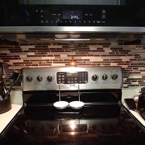 Stove top with clock showing 3:44 and cookware; Four Pack Microwave Light Bulbs Replacement for W10112515 in background