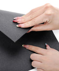 Peohud gasket paper sheet, black high-temperature non-asbestos gasket material, close-up of hands