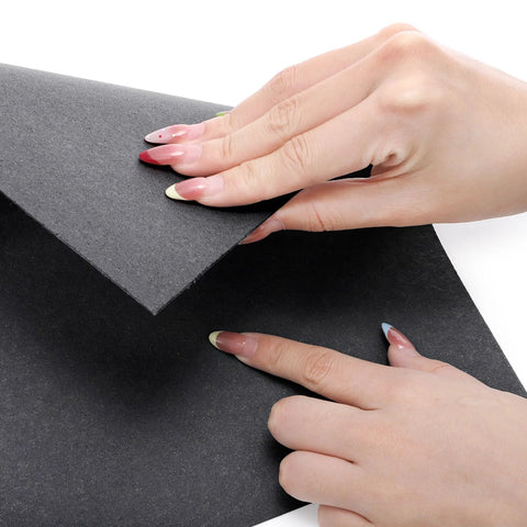 Peohud gasket paper sheet, black high-temperature non-asbestos gasket material, close-up of hands
