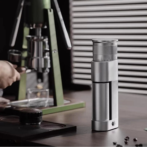 Premium Electric Coffee Grinder Featuring Game Changing Stepless Conical Burr Mill For Espresso And Pour Over Brewing, aluminum body on table.