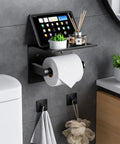 Mega Size Toilet Paper Holder With Built In Phone Shelf And Towel Hooks in matte black mounted in bathroom scene