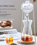 Top Shelf Cold Brew Drip Tower And Ice Coffee Maker With Solid Reusable Filter Dripper and Smooth Adjustable Flow Valve For Chill Ready Coffee Sips And No Mess Home Brewing, with ice and brewed coffee in glass.