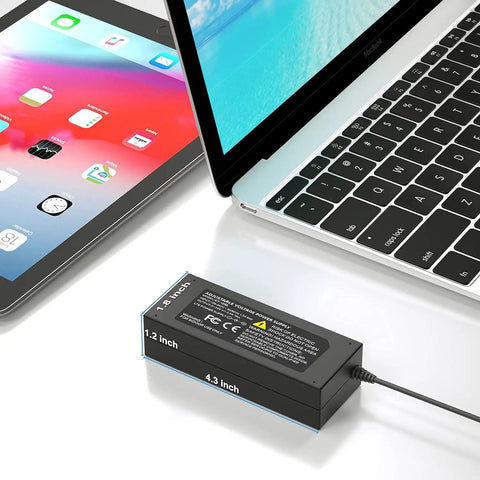 Beefed Up 60W Adjustable 24V Power Supply With LED Voltage Display connected to laptop and tablet, showing dimensions.