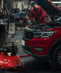 Mechanic using 6 Gallon Pancake Air Compressor 150 PSI Portable Oil Free With 10 Piece Accessory Kit in car garage
