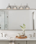 36-Inch 4-Light Modern Industrial Vanity Light With Metal Cage Shades In Brushed Nickel Finish for bath and powder room installed above mirror.
