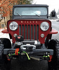 Front view of a red Jeep with Heavy Duty Three Eighth Inch Synthetic Shackle NexGen PRO Gator Jaw in red and black attached