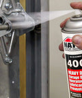 Applying Heavy Duty Garage Door Lubricant Spray With Rust Preventative And Long Lasting Hinge And Track Protection