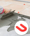 Red 50 Pack U Shaped Tile Spacers One Eighth Inch For Leveling shown during tile installation with mortar spreader.