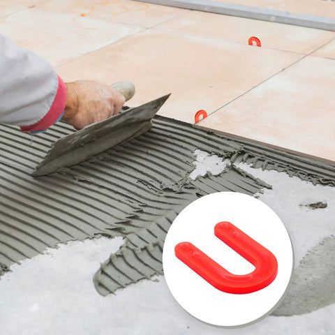 Red 50 Pack U Shaped Tile Spacers One Eighth Inch For Leveling shown during tile installation with mortar spreader.