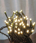 Close-up of 33Ft 100 LED Outdoor Waterproof String Lights Warm White For 12V Low Voltage Landscape Lighting wrapped in green wire