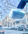 EZ Pass transponder mounted with Two Sets Of No Brainer Easy Peel And Stick Mounting Strips For EZ Pass IPass IZoom SunPass Transponders Quick On Windshield Or Dashboard Reclosable Dual Lock Tape For Your Car visible through car windshield.