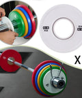 0.5 Kg Barbell Change Plate With Grooved Inner Design for Stable Lifts, shown in white next to multicolored plates