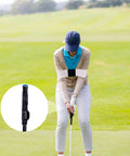 Golfer using Golf Grip Trainer Attachment And Swing Correcting Arm Band For Righties And Lefties A Handy Training Aid To Improve Hand Positioning Swing Mechanics Muscle Memory And Daily Practice Warmups in a field, with the grip trainer highlighted inset.