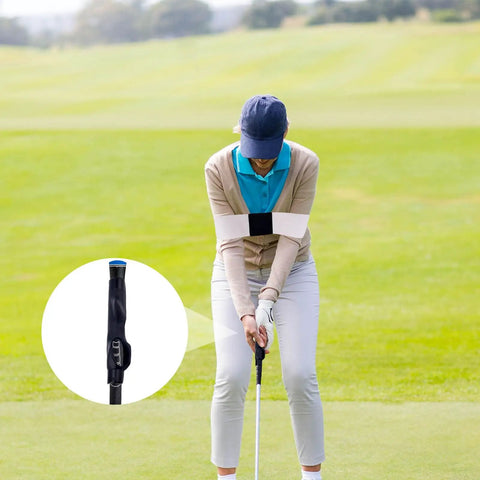 Golfer using Golf Grip Trainer Attachment And Swing Correcting Arm Band For Righties And Lefties A Handy Training Aid To Improve Hand Positioning Swing Mechanics Muscle Memory And Daily Practice Warmups in a field, with the grip trainer highlighted inset.