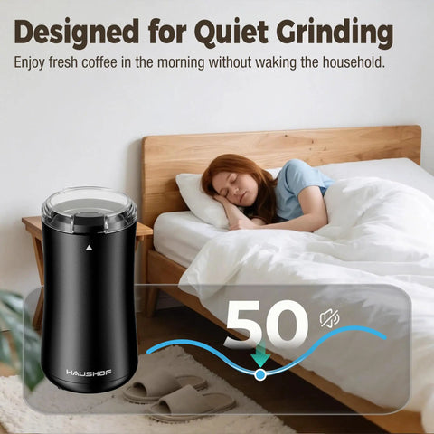 One Touch Electric Coffee Grinder for Beans, Spices, Herbs and Seeds, compact black kitchen mill next to a sleeping person