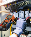 Technician using 6000 Counts TRMS Digital Multimeter With NCV And Auto Ranging, Measures AC DC Voltage And Current, in electrical panel