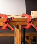 9 Inch Heavy Duty Spring Clamps With Kickass Grip Rock Solid Build Hella Durable Engineering Plastic And Soft Bi Material Handles Sweet For Woodworking And Quick Shop Fixes 2 Piece Set on wooden table.