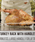 Cook lifting turkey on V Shaped Stainless Steel Turkey Roasting Rack For Oven And Kamado Grills, with large handles for lifting.
