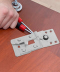 Installation of 2 Piece Metal Sectional Sofa Clips For Couch Connector on wooden surface with tools nearby.