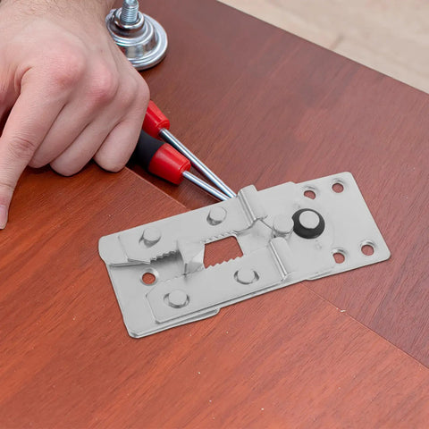 Installation of 2 Piece Metal Sectional Sofa Clips For Couch Connector on wooden surface with tools nearby.