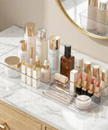 14 Pcs Clear Plastic Drawer Organizer Set With Two Extra Large 15X6 Trays, displaying makeup and skincare on vanity counter.