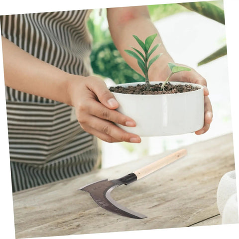 Portable Manganese Sickle For Garden Weeding And Harvesting With Ergonomic Handle beside potted plant on wooden table