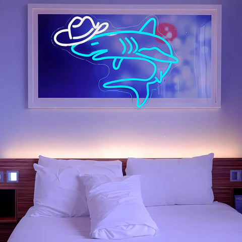 Shark neon sign with hat above bed, vibrant glow, decor for hangouts and teen room vibes