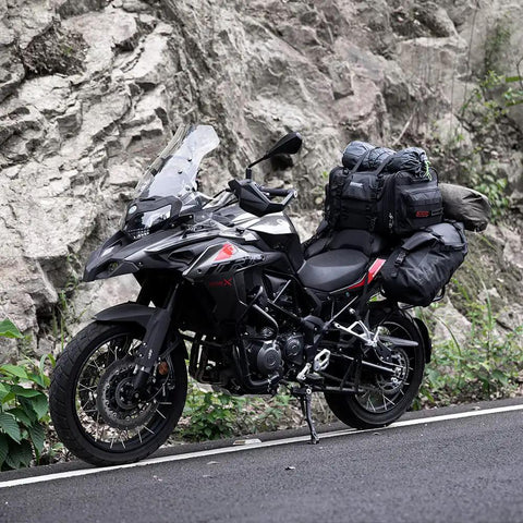 Expandable Motorcycle Tail Bag 60L Waterproof All Weather Travel Luggage For Trunk Rack With Sissy Bar Straps Rain Cover And Large Capacity From 40L To 60L Road Trip Ready Black mounted on a motorcycle parked by a rocky roadside