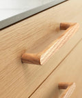 Close-up of Walnut Round Wooden Drawer Pulls 5 Inch Four Pack for Cabinets and Kitchen Doors showing smooth wood finish on cabinet