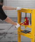 Dead Serious 12 Ton Hydraulic H Frame Shop Press With No Sweat Adjustable Table and knockout steel plates, user operating handle.