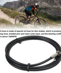 Black hydraulic brake hose coil with olive connectors, 2m, displayed in front of a mountain biker; Hydraulic Brake Kit For SRAM Level Red Etap S700 S900 Elixir 2m Cable Length Olive Connectors And Oil Needle Set Direct Replacement Aluminum And Nylon Construction For A Durable Ride Ready Bike Brake System Upgrade