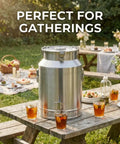 Top Shelf 304 Stainless Steel Water Dispenser With Airtight Lid And Snap Latches, Zero Drip Spigot For Hauling Wine Oil Or Milk, Backyard Ready Liquid Storage Barrel, 23 Gallon Tank on a picnic table outdoors.