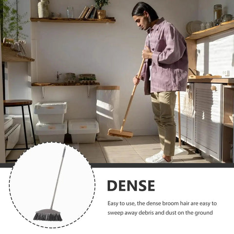 Dark Grey Angle Floor Broom With Long Stainless Steel Handle And Dense Stiff Bristles Snags Pet Hair Kitchen Messes And Daily Grime So Flipping Your Space Clean Is Total No Sweat Mode in use for cleaning debris.