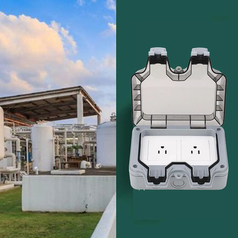 Tough As Nails IP66 Weatherproof Outdoor Electrical Outlet Box Featuring Dual 15A Power Sockets and Rainproof Seal open with a backdrop of industrial structures.