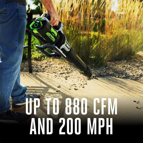 Person using Cordless Leaf Blower With Turbo Mode, 880 CFM At 200 MPH, Beast Power for quick yard cleanup on pavement.