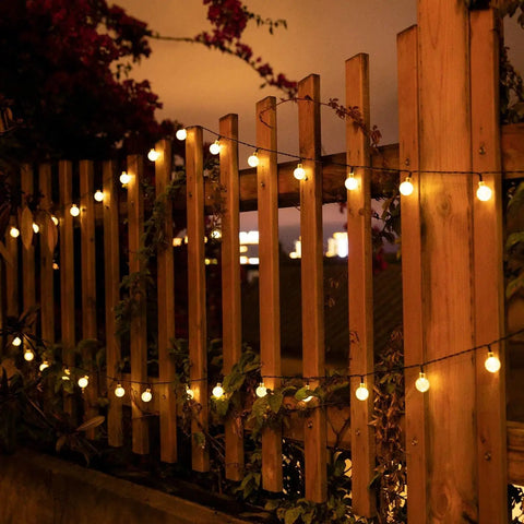 Outdoor 60 LED Globe String Lights Solar Powered 36 Ft with 8 Lighting Modes Waterproof on wooden garden fence