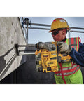 Worker using Onboard Dust Extractor for 1-1/8-Inch SDS Plus Rotary Hammers With Clear Dust Box and Replaceable Nozzle