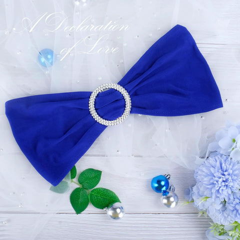 Royal Blue Spandex Chair Sashes Set Of 30 With Buckle Slider, ideal for wedding and banquet decor, shown with elegant floral accents.