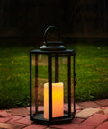 Outdoor Solar Powered Lantern With Flameless Candle For Porch Or Patio on brick, black metal and glass, dusk to dawn auto on