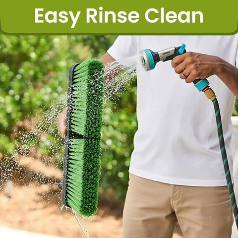 18 Inch Indoor Shop And Garage Push Broom With Soft Bristles being rinsed with a hose