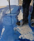 Person using Metallic Colored Epoxies 18 Inch Epoxy Trowel Spreader Tool for Epoxy Resin Floors And Walls, smoothing liquid on floor